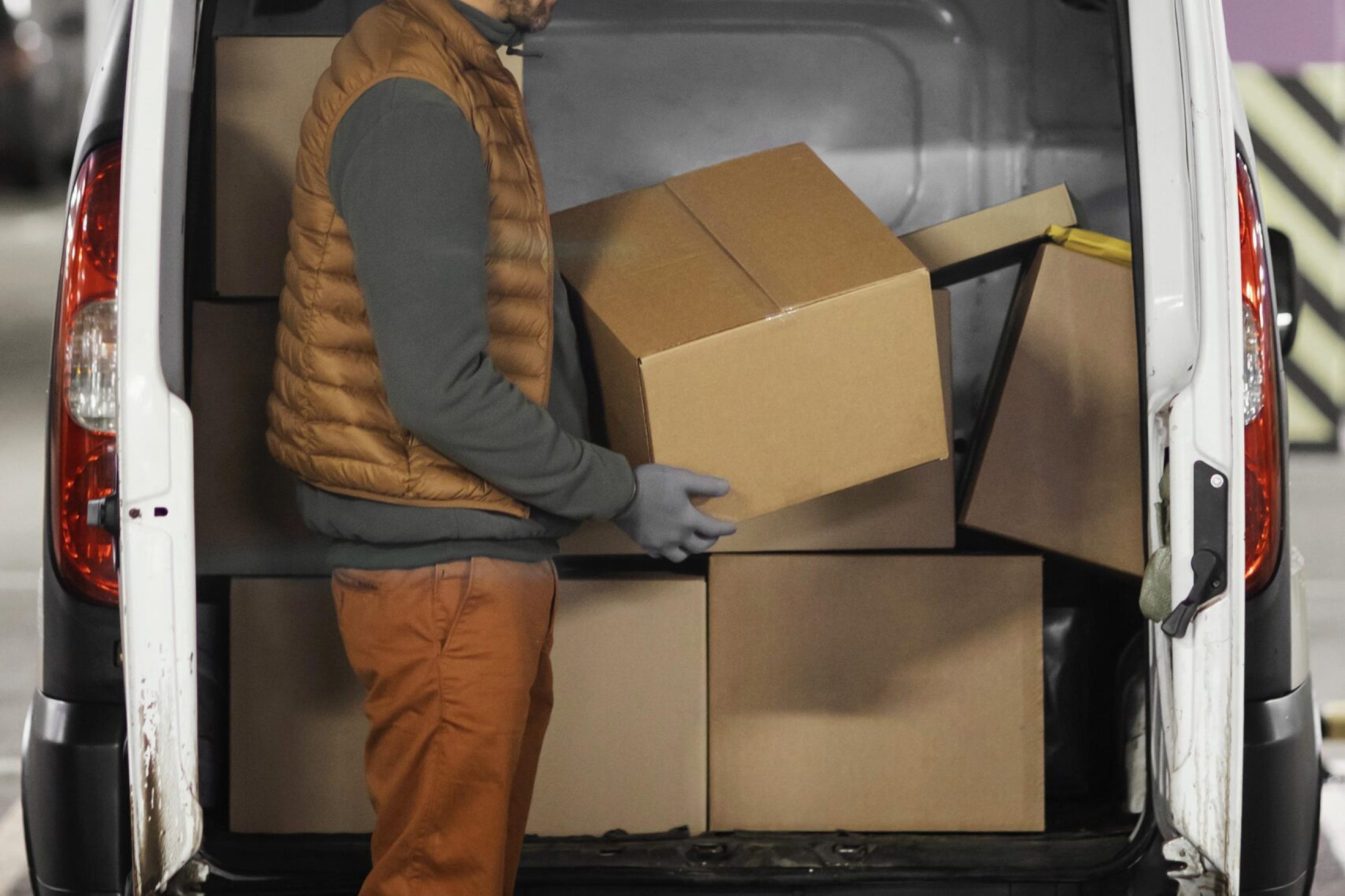 side-view-man-loading-car-with-packages
