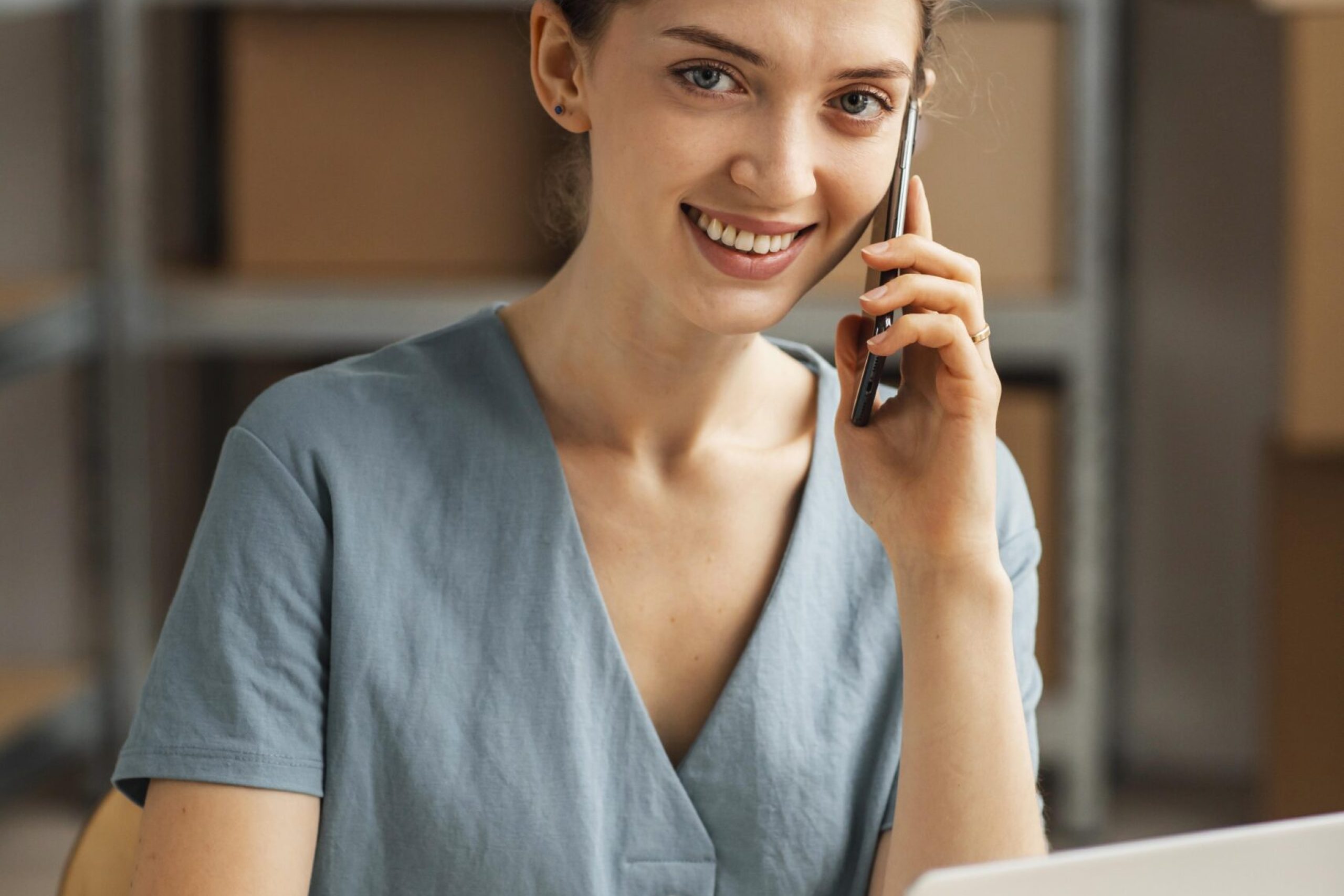 woman-working-laptop-talking-phone